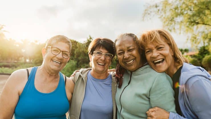 Happy multiracial female friends having fun smiling in front of the camera after training session at park